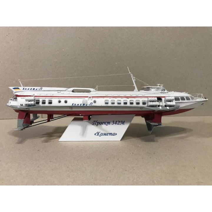 A model of the Soviet project 342M passenger ship 'Komet' displayed on a white stand against a plain beige background.