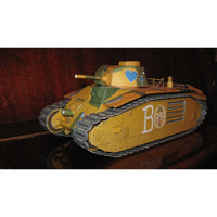 A yellow and green toy tank model with a blue heart emblem on the turret, displayed on a dark reflective surface against a dark wood background.