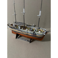 A detailed model of the historic ship Herblock's Oceanic (1769) on a wooden display stand, photographed against a neutral beige background.