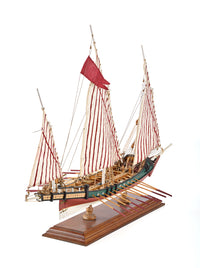 Photo of Amati Greek Galley 1:65 wooden model ship kit with sails and wooden base, depicting a historic Greek warship from the War of Independence.
