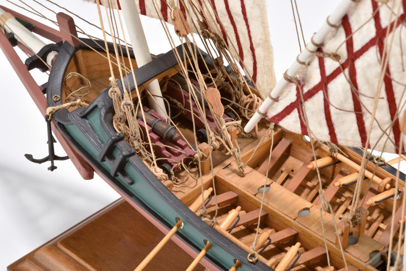 Photo of Amati Greek Galley 1:65 wooden model ship kit with sails and wooden base, depicting a historic Greek warship from the War of Independence.