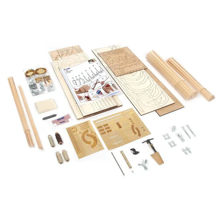 A wooden model kit laid out on a white background, including wooden sticks, engraved panels, screws, nuts, washers, and an instruction sheet.