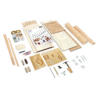 A wooden model kit laid out on a white background, including wooden sticks, engraved panels, screws, nuts, washers, and an instruction sheet.