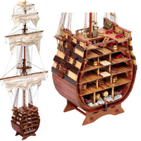 Photo of the Santísima Trinidad cross-section model kit by OcCre in 1/90 scale, showcasing detailed inner ship structure and mainmast elements.