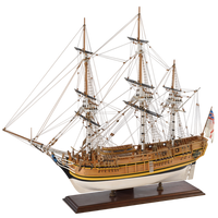Image showcasing the Amati HMS Bounty wooden model kit, featuring detailed components for assembling a scale replica of the historic 18th-century British naval ship, complete with intricate rigging, sails, and deck structures.