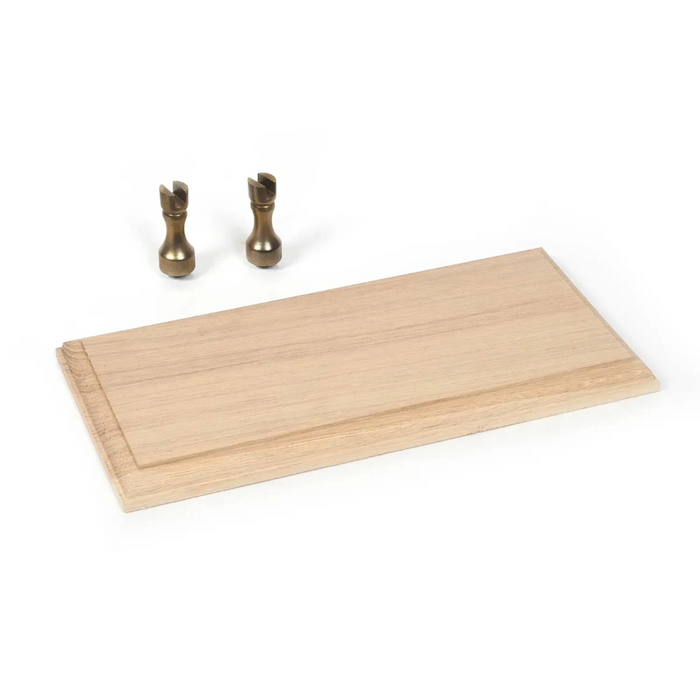 Photo of the OcCre 19164 Solid Oak Ship Model Display Base with two brass brackets, measuring 250x120x15mm, ideal for showcasing ship models.