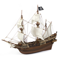 Photo of OcCre Buccaneer Pirate Ship 1:100 Wooden Model Kit fully assembled, showing detailed sails, wooden hull, and rigging.