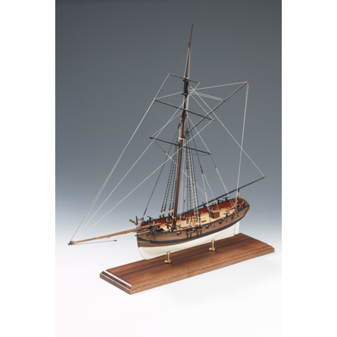 Image of Amati's Lady Nelson model ship, displaying its intricate design and craftsmanship. The model features detailed rigging, a meticulously crafted deck, and an authentic wooden hull, representative of early 19th-century naval vessels. The image captures the historical elegance and complexity of this iconic ship model, ideal for maritime enthusiasts and collectors.