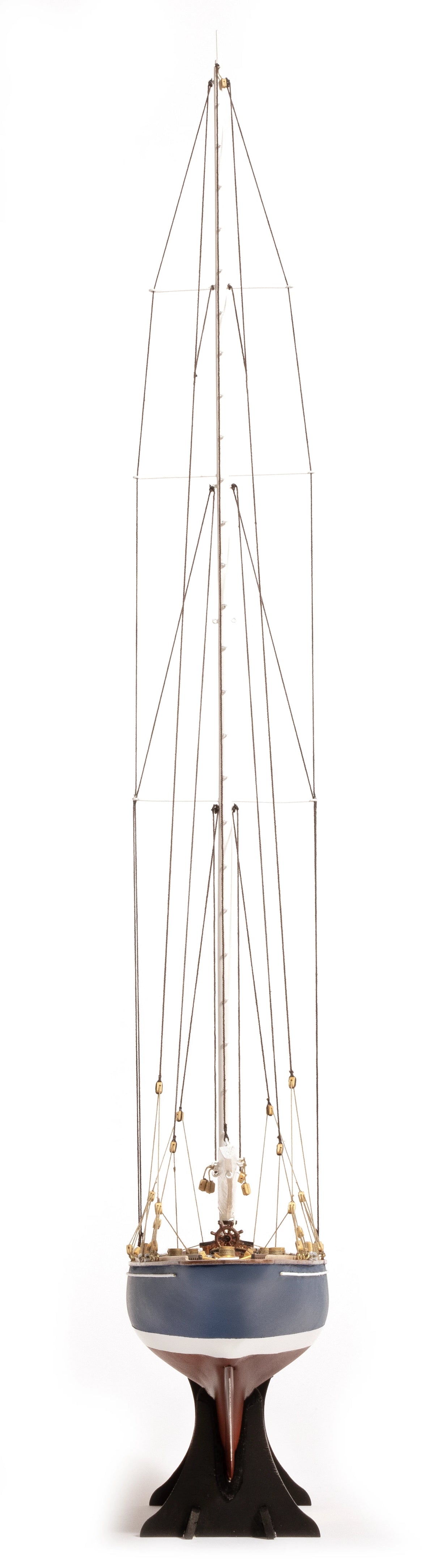 Photo of the OcCre Endeavour America's Cup yacht model kit in 1:75 scale, showing detailed wooden hull, rigging, and classic sail design.