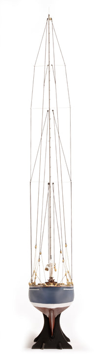 Photo of the OcCre Endeavour America's Cup yacht model kit in 1:75 scale, showing detailed wooden hull, rigging, and classic sail design.