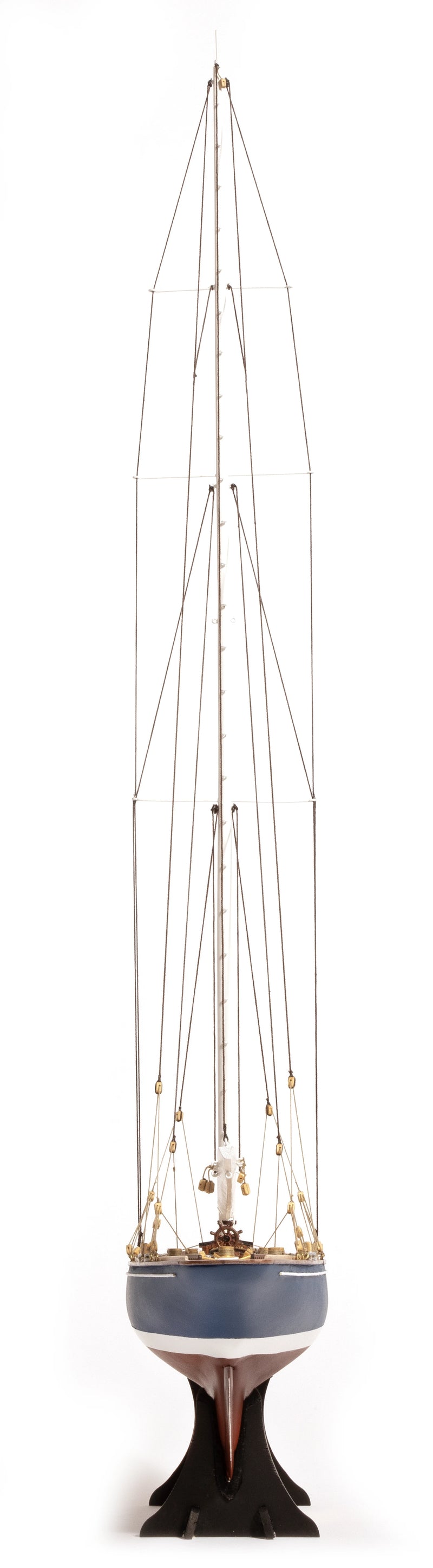 Photo of the OcCre Endeavour America's Cup yacht model kit in 1:75 scale, showing detailed wooden hull, rigging, and classic sail design.