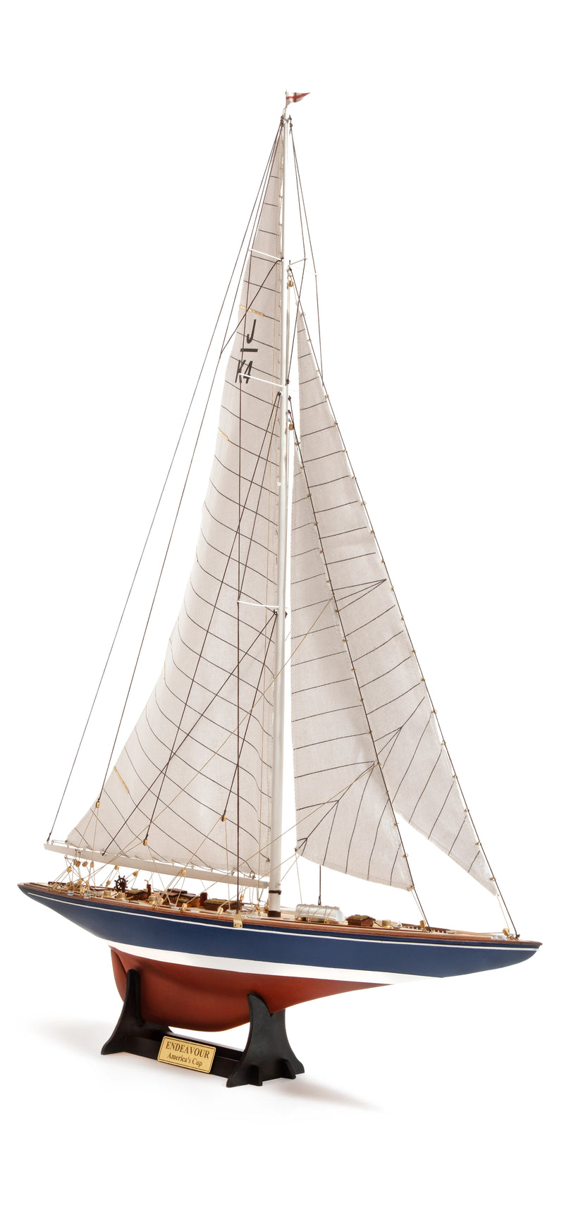 Photo of the OcCre Endeavour America's Cup yacht model kit in 1:75 scale, showing detailed wooden hull, rigging, and classic sail design.