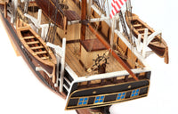 Photo of OcCre Essex 1:60 scale wooden model ship kit with detailed rigging and historical design