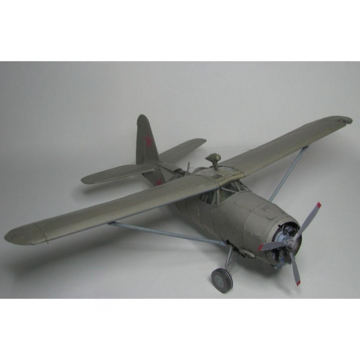 A scale model of a Soviet military aircraft, likely a Yak-150, in a matte gray livery with small red star insignias on the tail, photographed on a neutral gray background.
