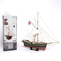 Model ship with a flag next to its packaging on a white background