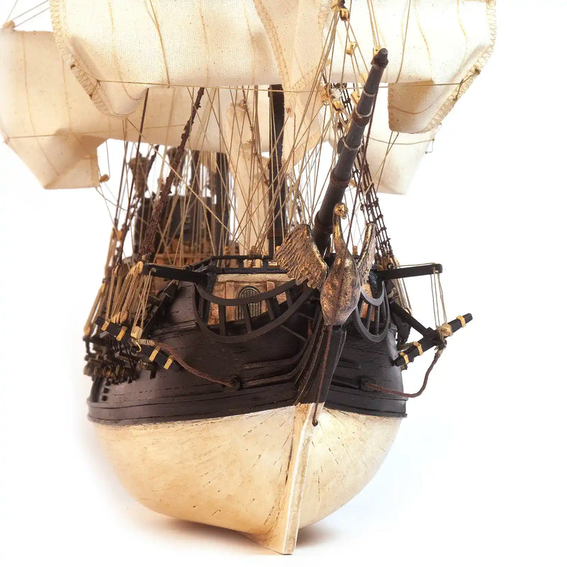 Photo of OcCre Black Swan wooden model ship kit 1:75 scale, detailed pirate vessel with sails and nameplate