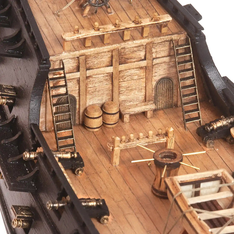 Photo of OcCre Black Swan wooden model ship kit 1:75 scale, detailed pirate vessel with sails and nameplate