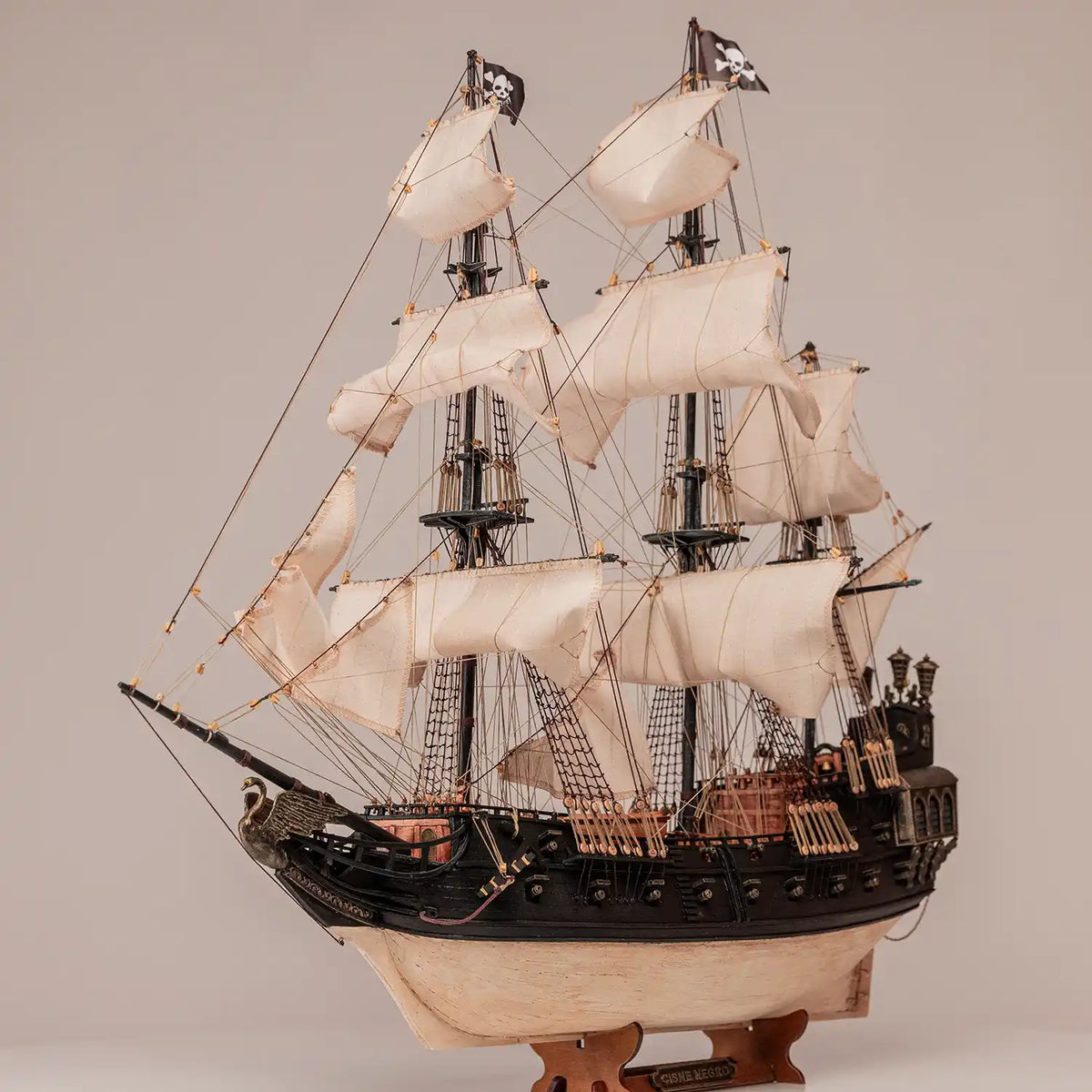 Photo of OcCre Black Swan wooden model ship kit 1:75 scale, detailed pirate vessel with sails and nameplate