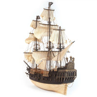 Photo of OcCre Black Swan wooden model ship kit 1:75 scale, detailed pirate vessel with sails and nameplate
