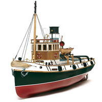 Photo of the Ulises Tug Boat Model Kit (1:30 Scale) by OcCre (61001), a detailed wooden and metal ship model featuring a steel hull, wooden crew areas, and intricate maritime details.