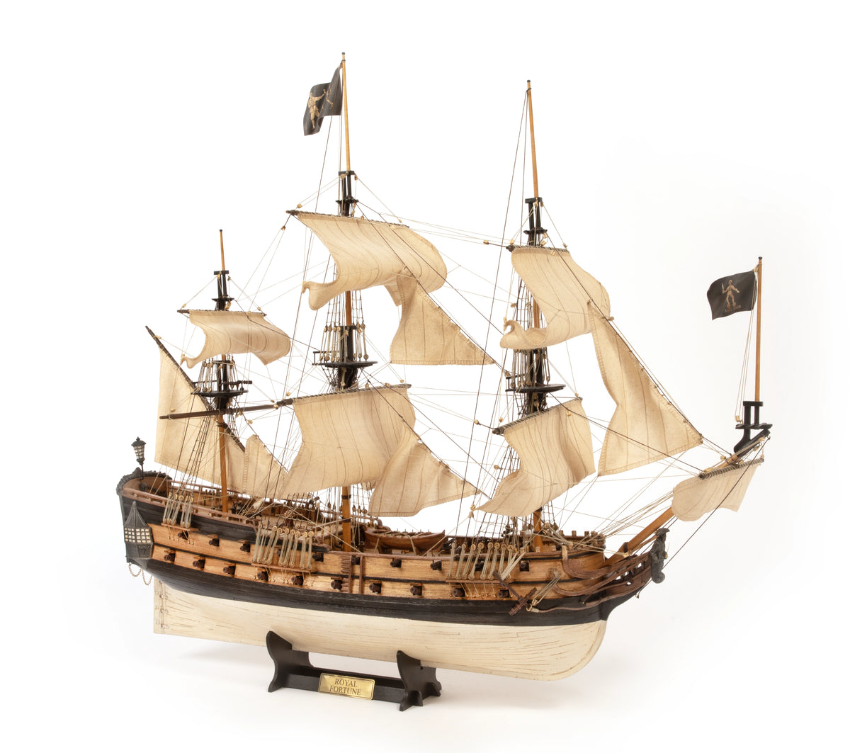 Model of a historical ship with multiple masts and sails on a white background