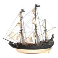 Photo of OcCre Black Swan wooden model ship kit 1:75 scale, detailed pirate vessel with sails and nameplate