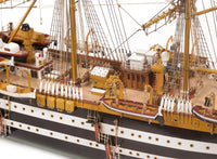 Photo of OcCre Amerigo Vespucci 1:100 wooden model ship kit without sails, showing detailed hull and brass photo-etch parts.