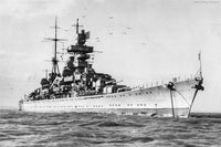 Black and white historical photograph of a large naval battleship at sea, with birds in the sky and a faint 'World War Photos' mark in the upper right corner.
