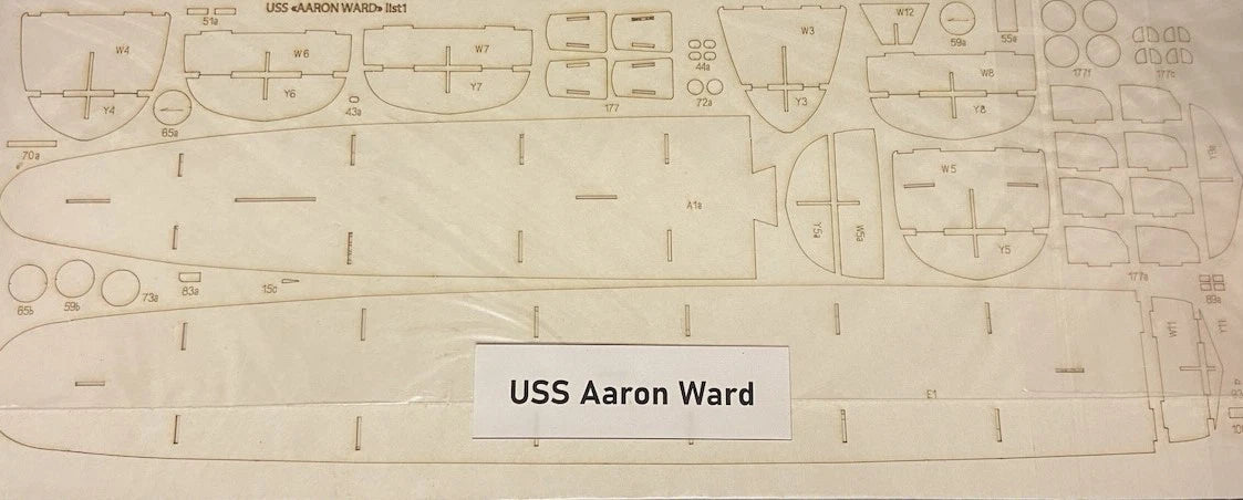 A flat printed template sheet for a model ship labeled 'USS Aaron Ward,' showing many outlined compartments and fittings on a light beige background.