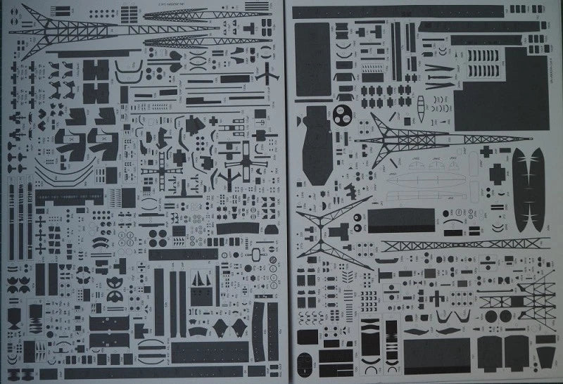 Two sheets of black model kit decals or stencils featuring various aircraft parts, towers, and geometric patterns on a white background.