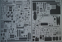 Two sheets of black model kit decals or stencils featuring various aircraft parts, towers, and geometric patterns on a white background.
