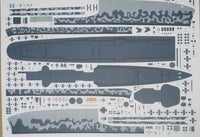 A sheet of model kit decals or transfer sheets featuring gray camouflage patterns and dark blue-gray ship or submarine-like silhouette shapes on a white backing.