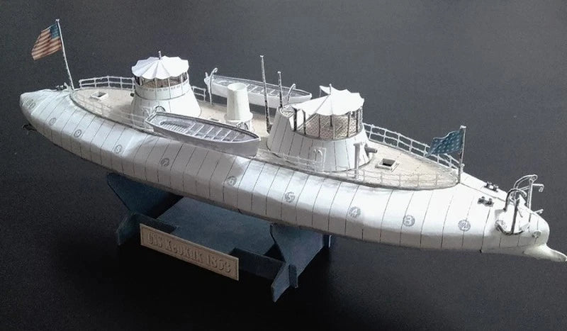 A detailed model of a historical submarine, identified as USS Missouri (BB-1992) from the text on the base plaque, shown on a dark background.