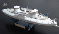 A detailed model of a historical submarine, identified as USS Missouri (BB-1992) from the text on the base plaque, shown on a dark background.