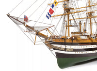 Photo of OcCre Amerigo Vespucci 1:100 wooden model ship kit without sails, showing detailed hull and brass photo-etch parts.