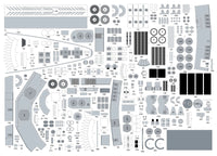 A flat lay sheet of many small gray and black molded pieces arranged in a grid, likely a model kit parts or assembly sheet, photographed on a white background.
