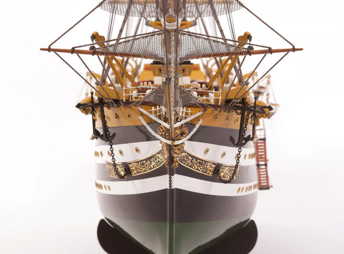 Photo of OcCre Amerigo Vespucci 1:100 wooden model ship kit without sails, showing detailed hull and brass photo-etch parts.