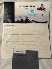Model kit parts sheet and instruction booklet for an IJN Furutaka 1942 model ship, branded Modelland, displayed on a light fabric background.