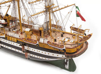Photo of OcCre Amerigo Vespucci 1:100 wooden model ship kit without sails, showing detailed hull and brass photo-etch parts.