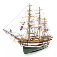 Photo of OcCre Amerigo Vespucci 1:100 wooden model ship kit without sails, showing detailed hull and brass photo-etch parts.