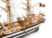 Photo of OcCre Amerigo Vespucci 1:100 wooden model ship kit without sails, showing detailed hull and brass photo-etch parts.