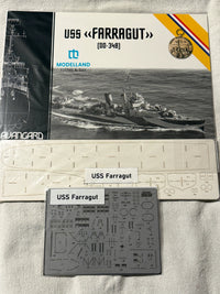 Alvargard Modelland USS Farragut (DD-348) model ship kit components laid out on a white fabric background, including the instruction booklet, white plastic parts sheet, and gray decals sheet labeled 'USS Farragut'.