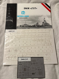 Model kit parts sheet and decal sheet for DKM Z37 model ship from Modelland, shown on a white fabric background.