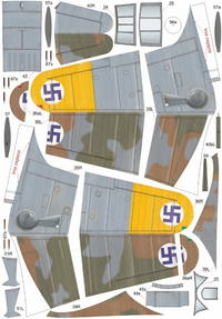 A sheet of cut model airplane wing and fuselage panels with printed markings, including gray camouflage sections, yellow nose sections, and blue-and-white swastika insignias, laid out on a white background.